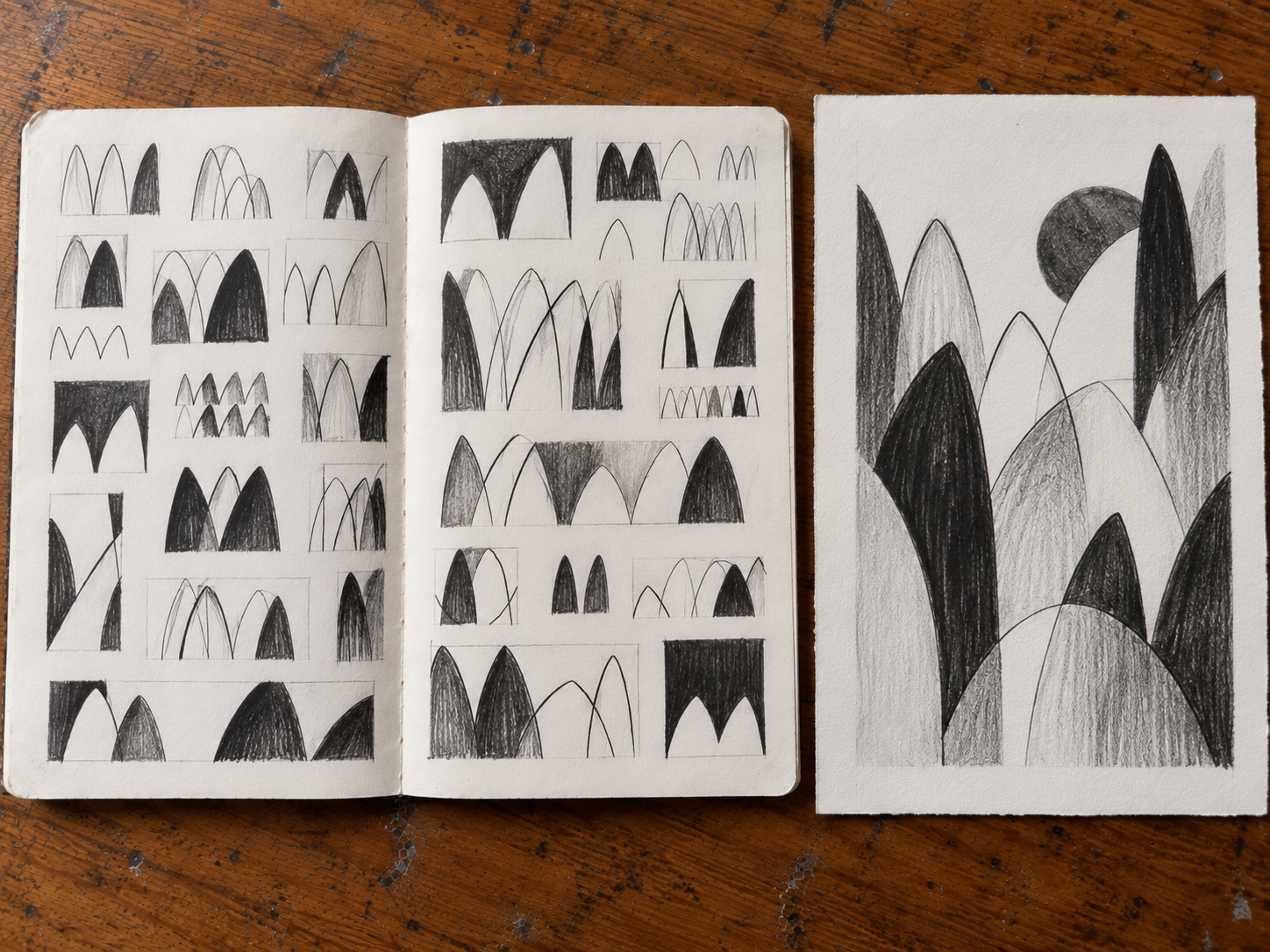 Open sketchbook showing established cat-derived forms becoming simpler, repeated and more sign-like.