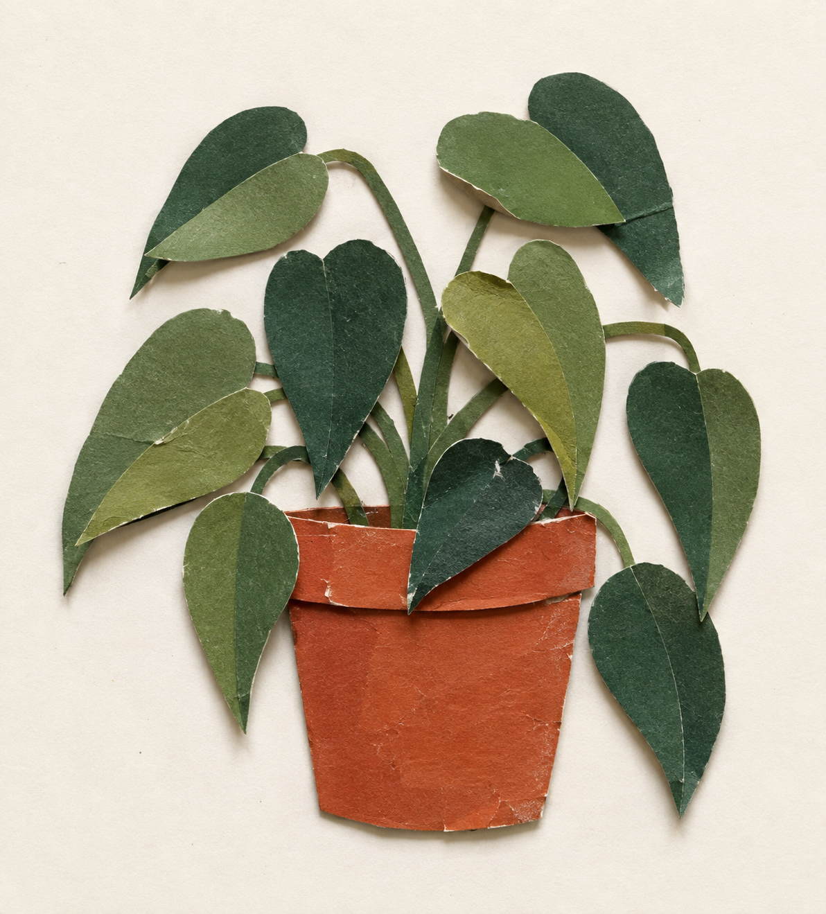 Handmade paper collage plant with cut green leaves, visible edges, layered overlaps and a terracotta pot, showing the evidence of making.