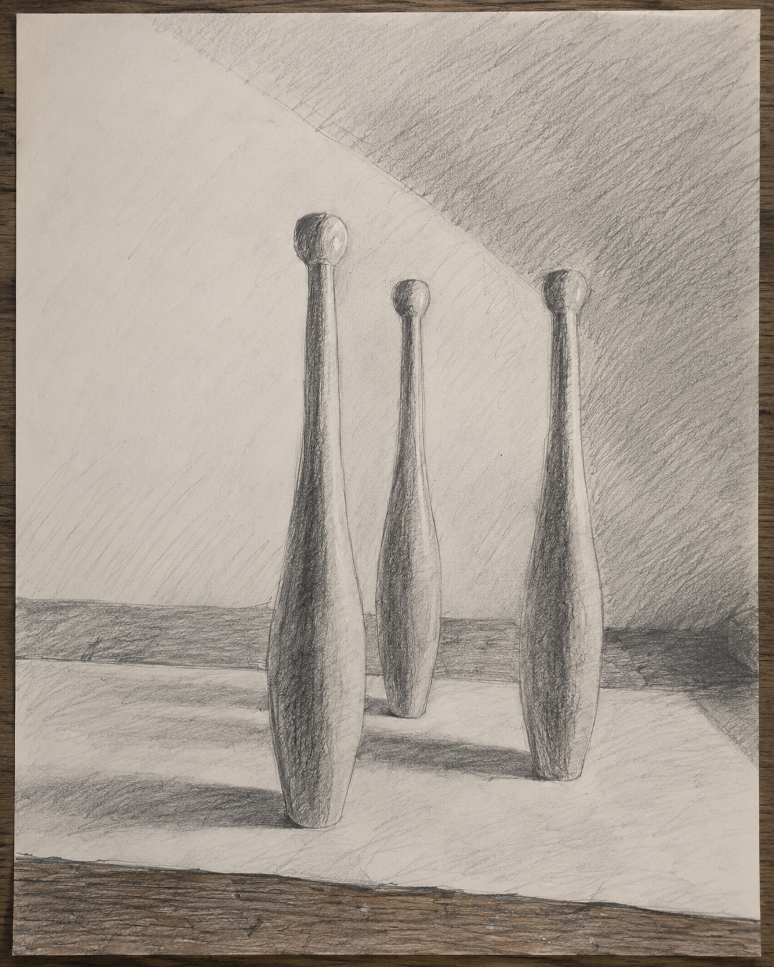 Student studio study — three wooden forms drawn in graphite, showing light side, shadow side, darker tones, reflected light and cast shadow.
