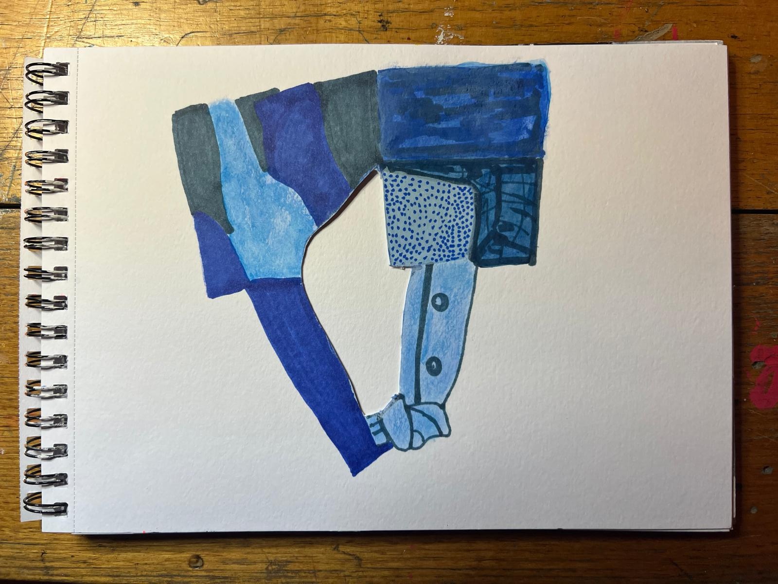 A hand made painted response in the sketchbook, worked in blues and greys, developed from the shapes, spaces, colours and relationships in the collage.