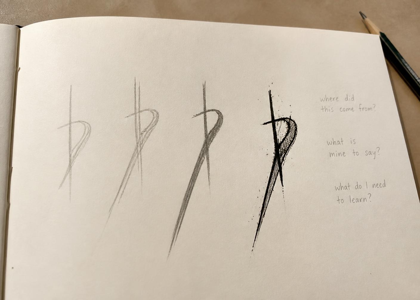 A visual diary page on a studio table showing one graphite mark in three earlier versions and a more developed ink version, with small handwritten pencil notes beside them asking where did this come from, what is mine to say, and what do I need to learn.